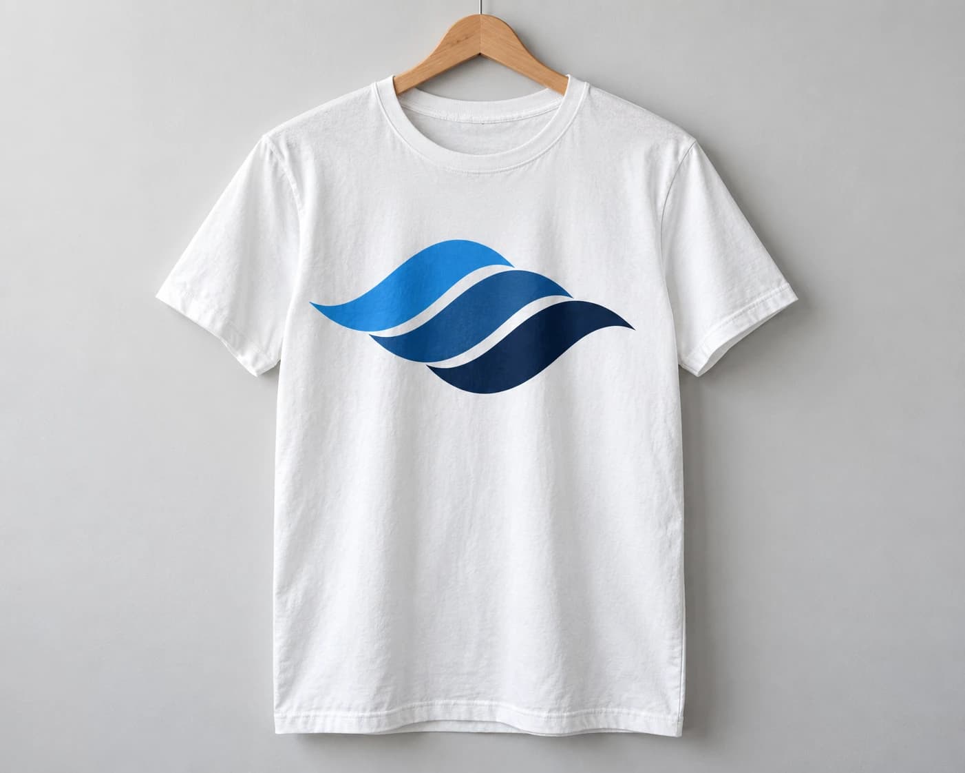 White T-shirt on a wooden hanger with a navy and blue wave print on the chest